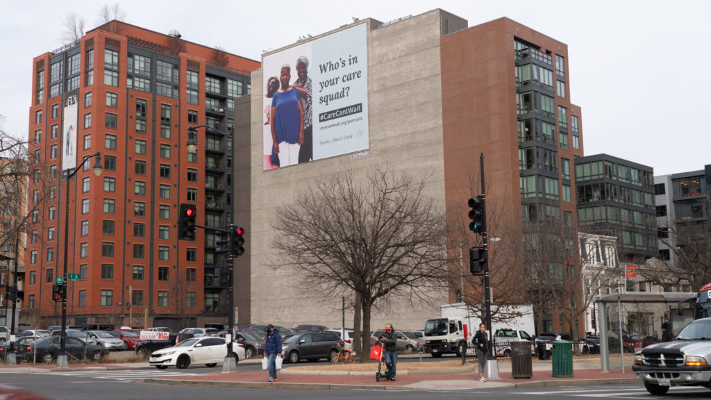 Portraits of Care Ad on a building in DC