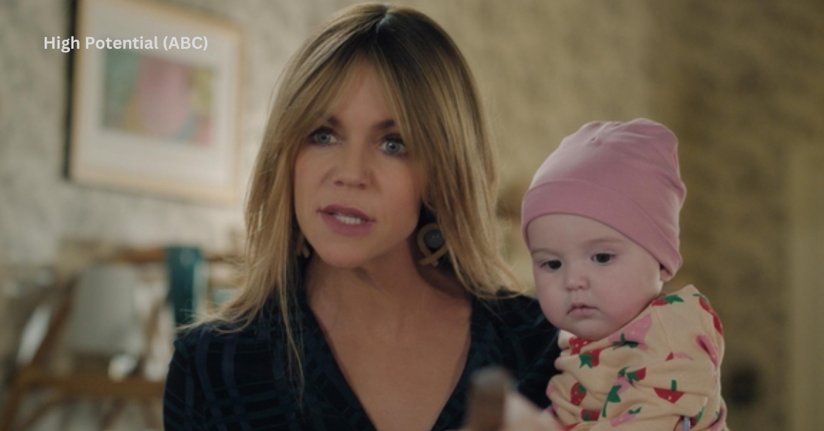 A woman holding a baby while speaking to someone with intensity.