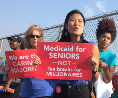 A photo of women holding signs at a protest that say, 