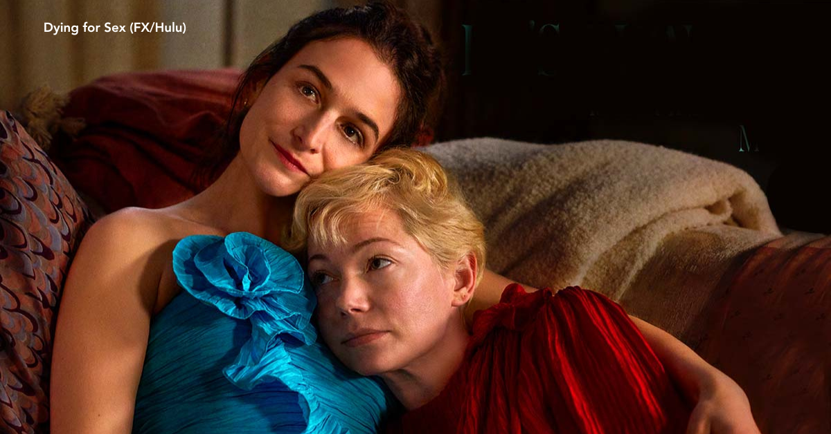 Two women cuddling on their couch.