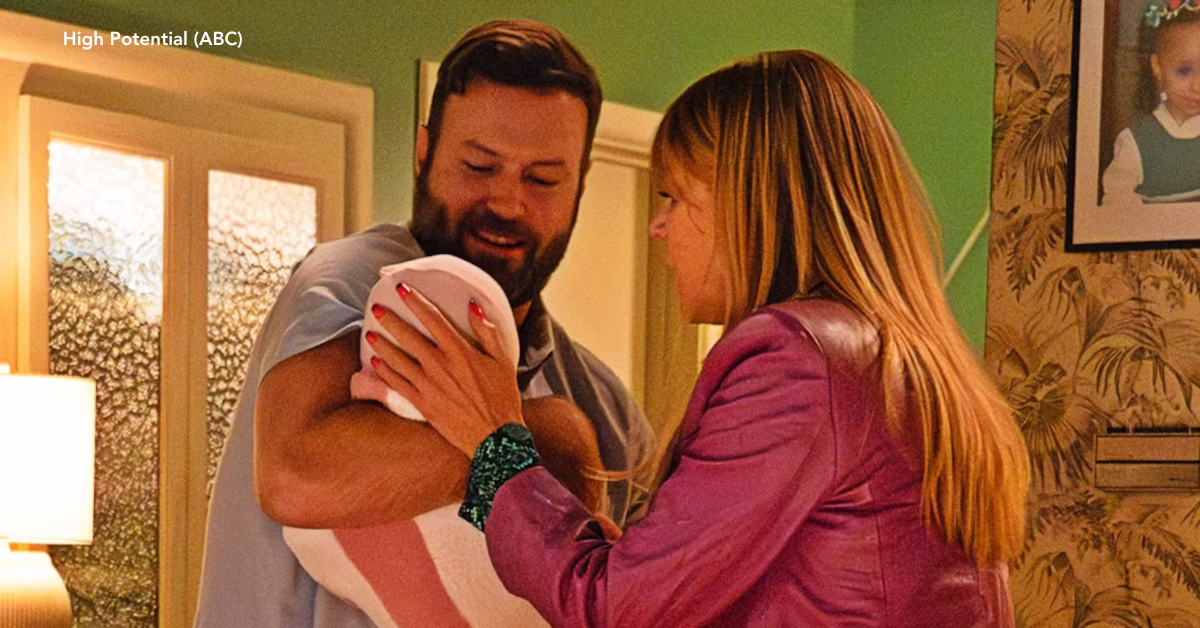 A man and woman embracing their newborn child.