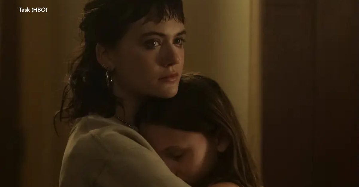 A woman starring into the distance and a young girl hugging each other.