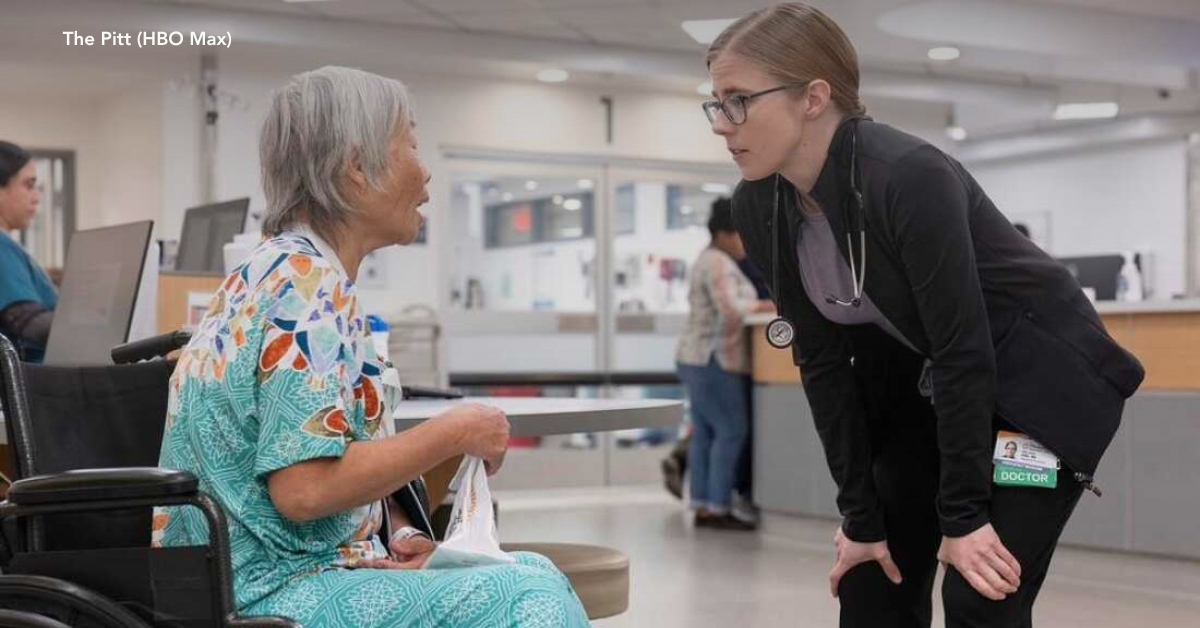 A nursing home worker speaking to an elderly resident.
